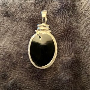 Silver and black pendant.